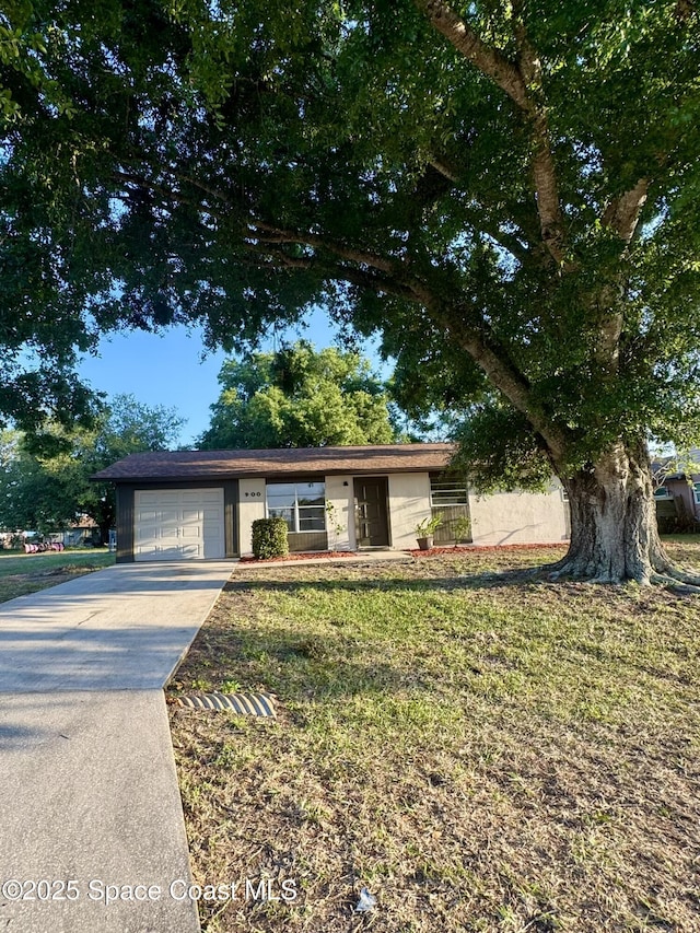 ranch-style house with a garage, a front lawn, and concrete driveway
