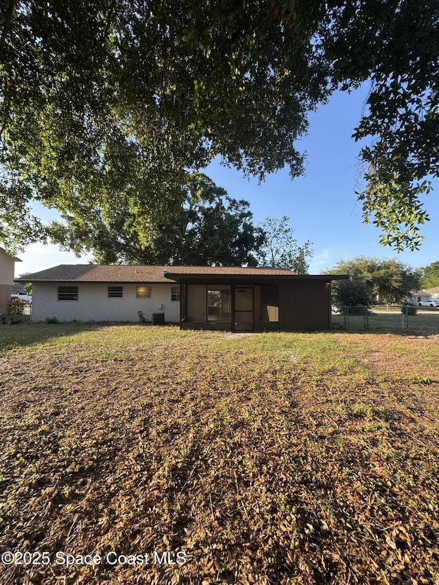 back of house with fence