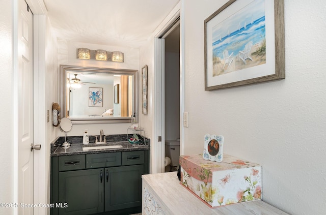 100 Canebreakers Dr Unit 112, Cocoa, FL 32927 - bathroom featuring vanity, a ceiling fan, and toilet