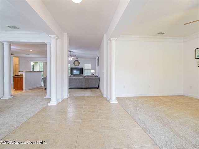 entrance foyer with ceiling fan, decorative columns, visible vents, and light colored carpet