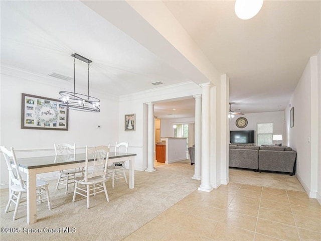 dining space with ornate columns, plenty of natural light, light tile patterned floors, and light carpet