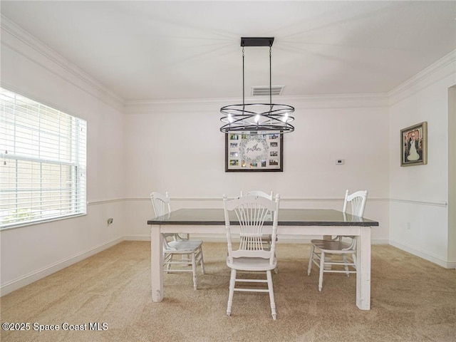 dining room with crown molding, visible vents, a chandelier, and light colored carpet