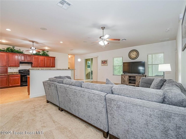 living room featuring visible vents, recessed lighting, ceiling fan, and light colored carpet