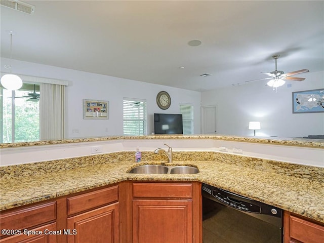 kitchen with visible vents, a sink, black dishwasher, and a wealth of natural light