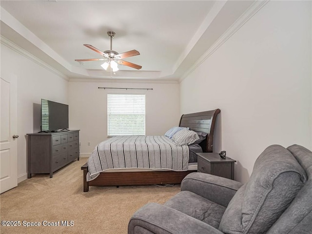 bedroom featuring a raised ceiling, ceiling fan, light carpet, and baseboards