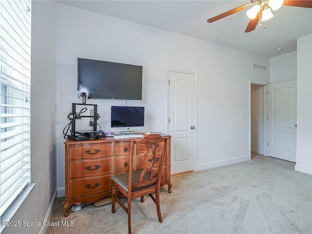 carpeted office featuring visible vents, baseboards, and ceiling fan