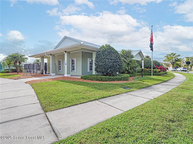 view of front of home with stucco siding and a front yard