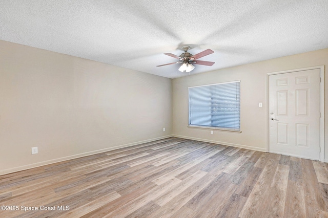 1515 N Huntington Ln Unit 415, Rockledge, FL 32955 - unfurnished room with baseboards, a ceiling fan, light wood finished floors, and a textured ceiling