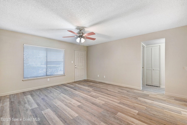 1515 N Huntington Ln Unit 415, Rockledge, FL 32955 - spare room with a textured ceiling, ceiling fan, baseboards, and light wood finished floors