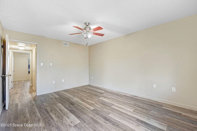 1515 N Huntington Ln Unit 415, Rockledge, FL 32955 - spare room featuring ceiling fan, a textured ceiling, baseboards, wood finished floors, and visible vents
