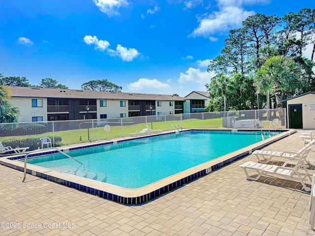 1515 N Huntington Ln Unit 415, Rockledge, FL 32955 - community pool featuring a patio, a lawn, and fence