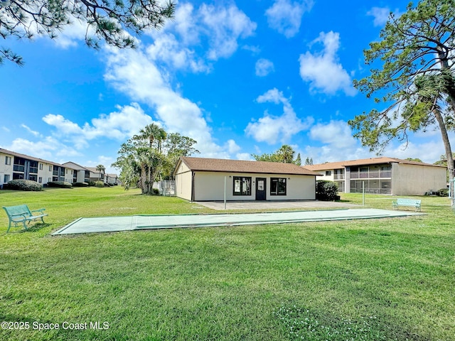 1515 N Huntington Ln Unit 415, Rockledge, FL 32955 - rear view of house with a lawn and stucco siding