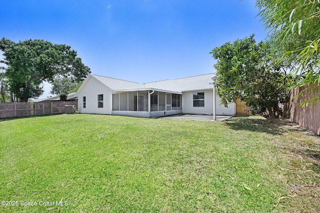 back of house with central AC unit, a sunroom, a fenced backyard, a yard, and a patio