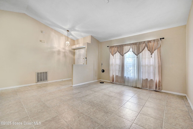 empty room with tile patterned floors, baseboards, lofted ceiling, and visible vents