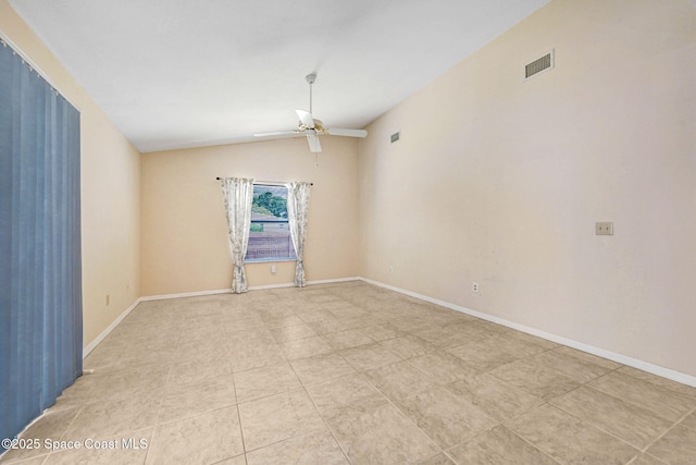 empty room featuring ceiling fan, baseboards, light tile patterned floors, vaulted ceiling, and visible vents