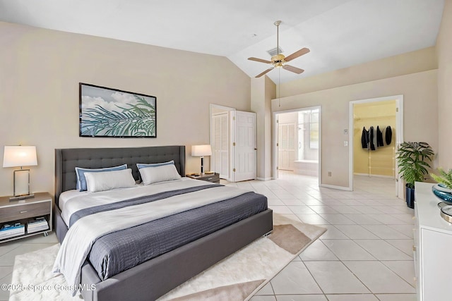 bedroom with light tile patterned flooring, baseboards, connected bathroom, a spacious closet, and a ceiling fan