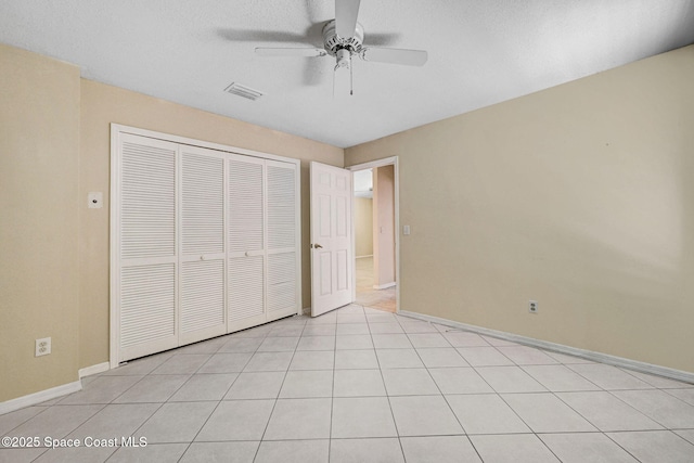 unfurnished bedroom featuring visible vents, a ceiling fan, baseboards, and a closet
