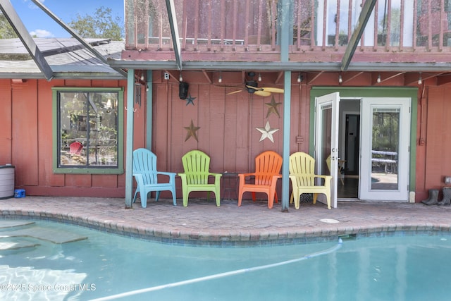 pool featuring ceiling fan and a patio area