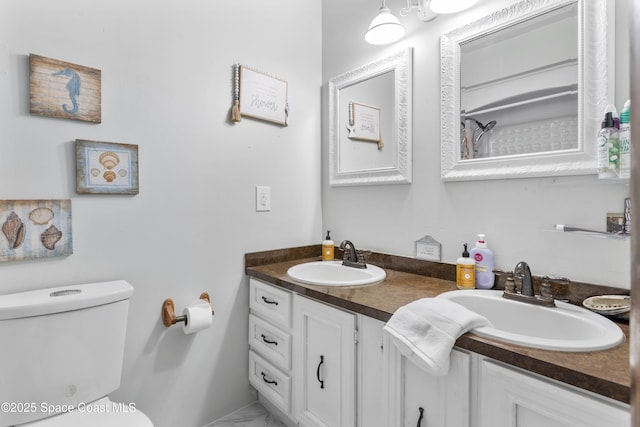 bathroom with double vanity, toilet, a sink, and marble finish floor