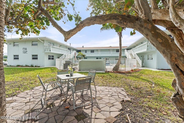 299 E Central Blvd Unit 6, Cape Canaveral, FL 32920 - view of patio with fence, outdoor dining area, and stairs