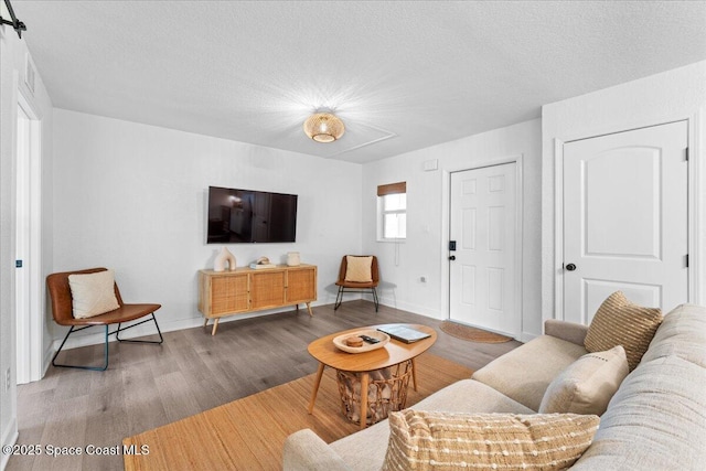 299 E Central Blvd Unit 6, Cape Canaveral, FL 32920 - living room with a textured ceiling, baseboards, and wood finished floors