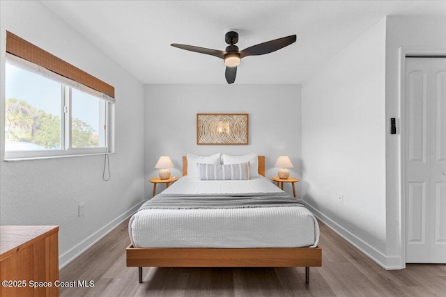 299 E Central Blvd Unit 6, Cape Canaveral, FL 32920 - bedroom featuring a ceiling fan, baseboards, and wood finished floors