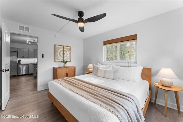 299 E Central Blvd Unit 6, Cape Canaveral, FL 32920 - bedroom with baseboards, visible vents, stainless steel fridge, and wood finished floors