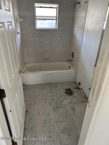 bathroom with bathing tub / shower combination