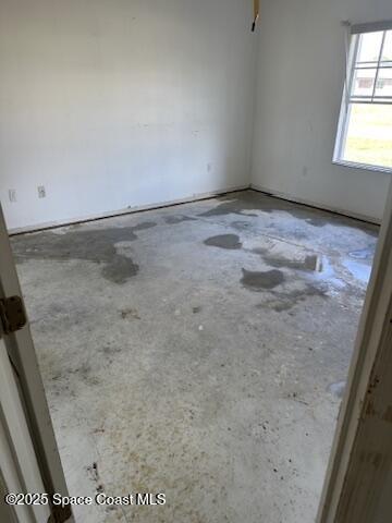 spare room featuring unfinished concrete floors
