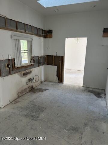 interior space featuring concrete flooring and a skylight
