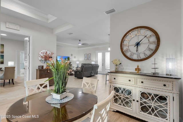 1401 Wyoming Dr SE, Palm Bay, FL 32909 - dining space featuring a tray ceiling, visible vents, ornamental molding, and light wood finished floors