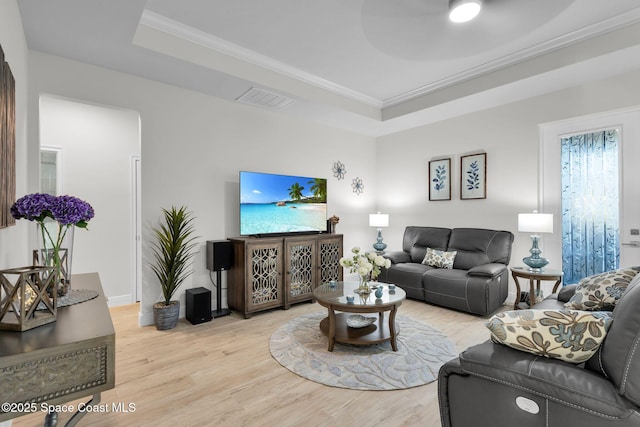 1401 Wyoming Dr SE, Palm Bay, FL 32909 - living room featuring crown molding, visible vents, light wood-style flooring, and a raised ceiling