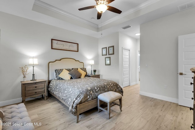 1401 Wyoming Dr SE, Palm Bay, FL 32909 - bedroom featuring a raised ceiling, ornamental molding, light wood finished floors, and visible vents