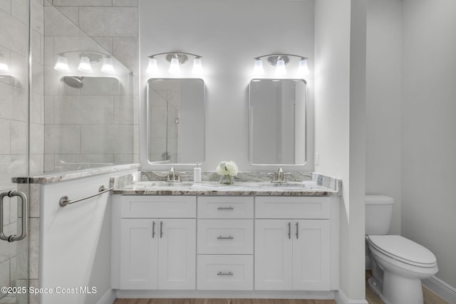 1401 Wyoming Dr SE, Palm Bay, FL 32909 - bathroom with a sink, a shower stall, toilet, and double vanity
