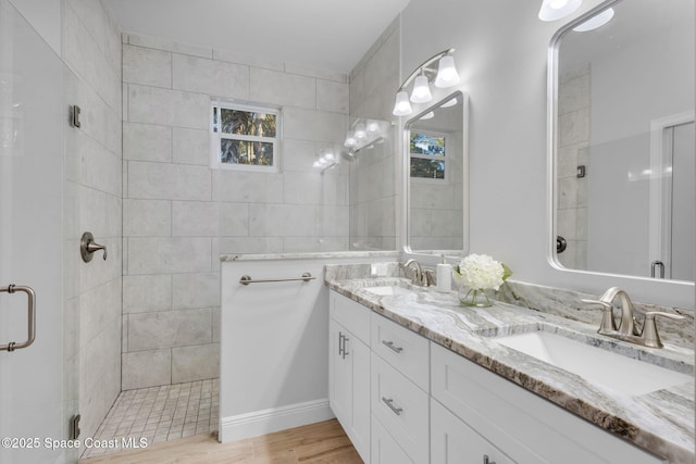 1401 Wyoming Dr SE, Palm Bay, FL 32909 - full bath with double vanity, a shower stall, a sink, and wood finished floors