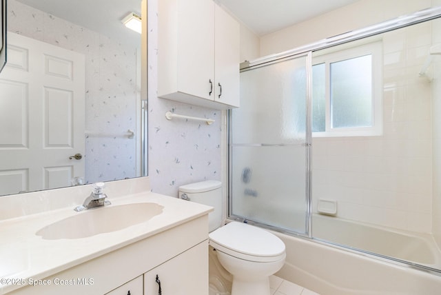 1523 Tippicanoe Ct, Melbourne, FL 32940 - full bath featuring toilet, combined bath / shower with glass door, vanity, and wallpapered walls