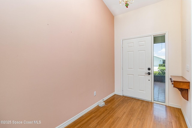 1523 Tippicanoe Ct, Melbourne, FL 32940 - entrance foyer featuring an inviting chandelier, light wood-style flooring, and baseboards