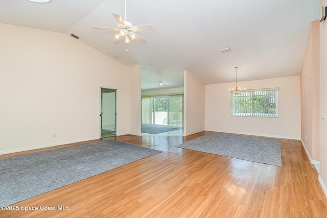 1523 Tippicanoe Ct, Melbourne, FL 32940 - spare room featuring baseboards, visible vents, ceiling fan with notable chandelier, vaulted ceiling, and light wood-type flooring