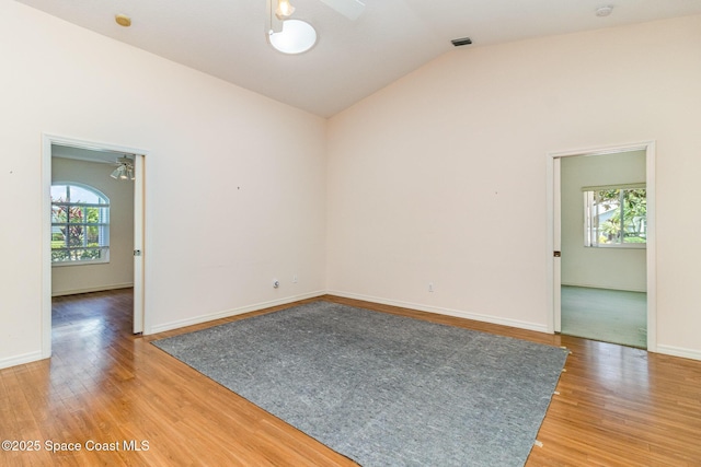 1523 Tippicanoe Ct, Melbourne, FL 32940 - empty room featuring lofted ceiling, light wood-style floors, a ceiling fan, and baseboards
