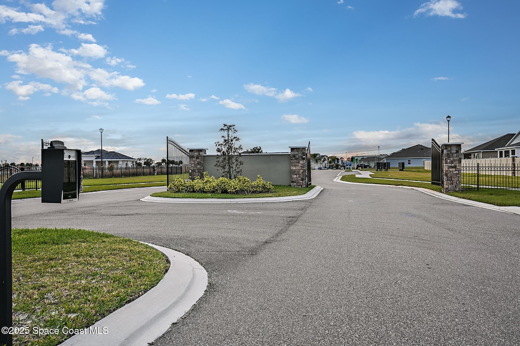 2512 Carrick St NW, Palm Bay, FL 32907 - view of asphalt road with street lighting, a residential view, and curbs