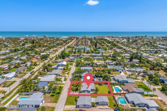 birds eye view of property with a water view and a residential view