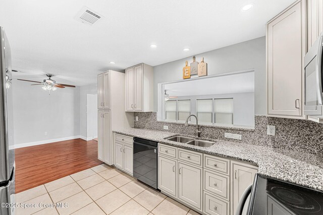 kitchen featuring a sink, electric stove, black dishwasher, a ceiling fan, and visible vents