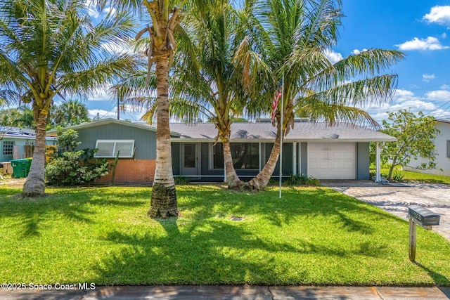 ranch-style home featuring an attached garage, driveway, and a front yard