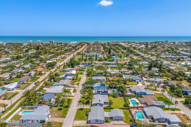 drone / aerial view featuring a residential view and a water view