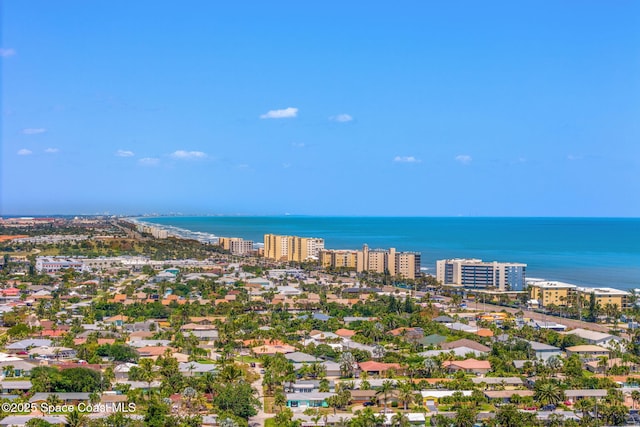 drone / aerial view featuring a view of city and a water view