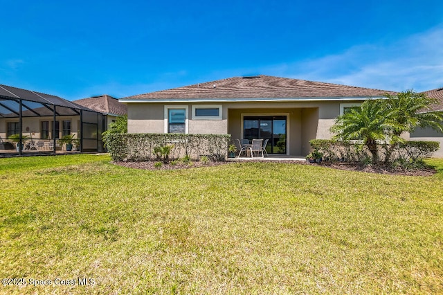 7447 Bluemink Ln, Melbourne, FL 32940 - back of property with stucco siding, a lawn, and a patio