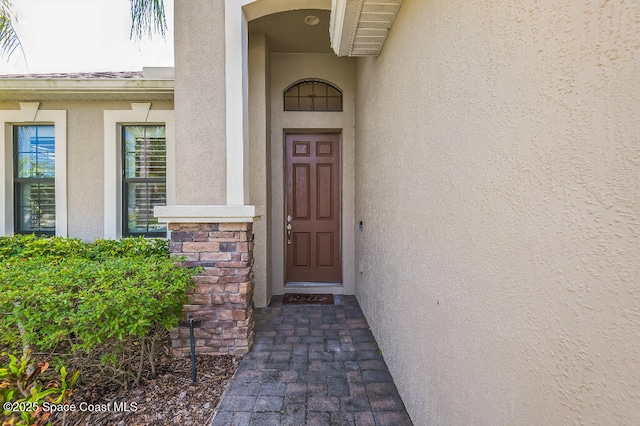 7447 Bluemink Ln, Melbourne, FL 32940 - doorway to property featuring stucco siding