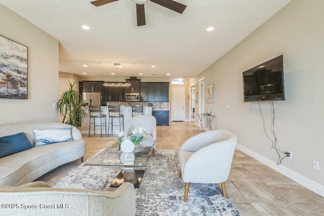 7447 Bluemink Ln, Melbourne, FL 32940 - living room featuring ceiling fan, recessed lighting, a textured ceiling, and baseboards