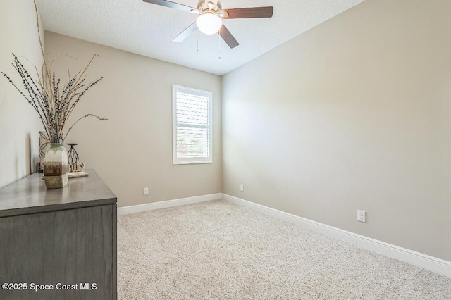 7447 Bluemink Ln, Melbourne, FL 32940 - empty room with baseboards, ceiling fan, light carpet, and a textured ceiling