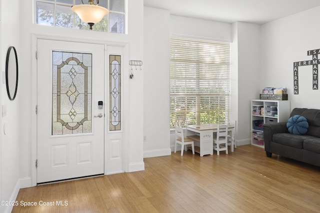 entryway featuring baseboards and hardwood / wood-style floors